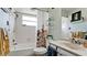Bright bathroom featuring a tub with shower, white vanity, floral shower curtain, and decorative shelving for a clean, modern feel at 1320 Bottlebrush Dr, Bradenton, FL 34208