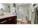 Bathroom with a white vanity, a framed mirror, and a glass-enclosed shower at 1320 Bottlebrush Dr, Bradenton, FL 34208