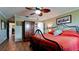 Comfortable bedroom features a decorative ceiling fan, wood-look flooring, and ample closet space at 1320 Bottlebrush Dr, Bradenton, FL 34208