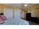 Comfortable bedroom featuring a ceiling fan, ample closet space, and a neutral color scheme at 1320 Bottlebrush Dr, Bradenton, FL 34208