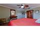 Cozy bedroom with a decorative ceiling fan, dresser with mirror, and wood-look flooring at 1320 Bottlebrush Dr, Bradenton, FL 34208