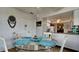 Bright breakfast nook with a glass table and views of the kitchen with white cabinets at 1320 Bottlebrush Dr, Bradenton, FL 34208