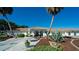 Inviting clubhouse entrance with decorative fountain, lush landscaping, and a well-maintained walkway at 1320 Bottlebrush Dr, Bradenton, FL 34208