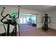 Well-equipped exercise room featuring modern equipment, including elliptical, treadmill and weight machines at 1320 Bottlebrush Dr, Bradenton, FL 34208