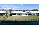 Waterfront home featuring lush landscaping and charming shutters at 1320 Bottlebrush Dr, Bradenton, FL 34208