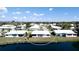 Waterfront home featuring lush landscaping and charming shutters at 1320 Bottlebrush Dr, Bradenton, FL 34208