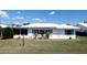 Waterfront home featuring lush landscaping and charming shutters at 1320 Bottlebrush Dr, Bradenton, FL 34208