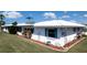 Waterfront home featuring lush landscaping and charming shutters at 1320 Bottlebrush Dr, Bradenton, FL 34208