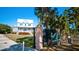Beautiful two-story blue home with a white porch, near entrance to Robinson Preserve with signage at 1320 Bottlebrush Dr, Bradenton, FL 34208