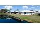 Waterfront home featuring lush landscaping and charming shutters at 1320 Bottlebrush Dr, Bradenton, FL 34208