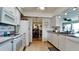 Bright kitchen featuring white cabinets, granite countertops, and modern appliances with an open view to the dining room at 1320 Bottlebrush Dr, Bradenton, FL 34208