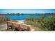 Scenic lake view with a wooden bench in the foreground, perfect for relaxation at 1320 Bottlebrush Dr, Bradenton, FL 34208