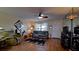 Cozy living room with a comfortable sofa, ceiling fan, wood-look tile flooring, and elegant decor at 1320 Bottlebrush Dr, Bradenton, FL 34208