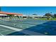 Well-maintained shuffleboard courts with covered seating areas and views of surrounding homes at 1320 Bottlebrush Dr, Bradenton, FL 34208