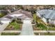 Aerial view of a single-story home with a well-maintained lawn, driveway, and mature landscaping at 13439 Norman Cir, Hudson, FL 34669