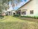 Manicured backyard with lush lawn and sunroom view from the property's exterior at 13439 Norman Cir, Hudson, FL 34669