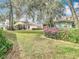Well-maintained backyard with manicured lawn and beautiful landscaping at 13439 Norman Cir, Hudson, FL 34669