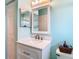 Well-lit bathroom with a vanity, storage, and classic fixtures at 13439 Norman Cir, Hudson, FL 34669