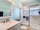 Bathroom featuring a shower with glass door, vanity, and marble countertop at 13439 Norman Cir, Hudson, FL 34669