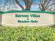 Elegant community sign for Fairway Villas at Meadow Oaks, surrounded by lush landscaping at 13439 Norman Cir, Hudson, FL 34669
