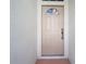 Close-up view of a front door with detailed trim and a decorative window above at 13439 Norman Cir, Hudson, FL 34669