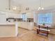 Bright kitchen with white cabinets, an eat-in nook, modern appliances, and natural lighting at 13439 Norman Cir, Hudson, FL 34669
