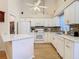 Well-lit kitchen with white cabinetry, modern appliances, breakfast bar, and updated countertops at 13439 Norman Cir, Hudson, FL 34669