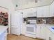 Bright kitchen features white cabinets, modern appliances, and a convenient pantry at 13439 Norman Cir, Hudson, FL 34669