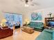 Comfortable living room featuring hardwood floors, neutral walls, and an expansive view at 13439 Norman Cir, Hudson, FL 34669
