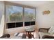 Relaxing screened patio with wicker furniture and view of the lush greenery at 13439 Norman Cir, Hudson, FL 34669
