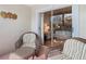 Cozy patio seating with a view into the bright bedroom with floral accents at 13439 Norman Cir, Hudson, FL 34669