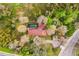 Aerial view of a large home surrounded by lush greenery and trees with a private pool at 14333 Lake Magdalene Blvd, Tampa, FL 33618