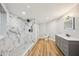 Spacious bathroom featuring a walk-in shower, modern vanity, and wood-look floors at 14333 Lake Magdalene Blvd, Tampa, FL 33618