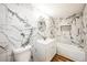 Stylish bathroom featuring marble-patterned tile walls, modern vanity, and soaking tub at 14333 Lake Magdalene Blvd, Tampa, FL 33618