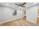 Bright bedroom features hardwood floors, a ceiling fan, and a window for natural light at 14333 Lake Magdalene Blvd, Tampa, FL 33618