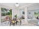 Cozy dining room featuring a glass table and a view of the well-maintained backyard at 14333 Lake Magdalene Blvd, Tampa, FL 33618