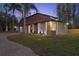 Beautiful home with manicured lawn and landscape lighting enhancing the exterior at 14333 Lake Magdalene Blvd, Tampa, FL 33618