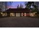 Charming home with a red front door and a circular stone driveway, creating a welcoming entrance at 14333 Lake Magdalene Blvd, Tampa, FL 33618