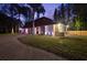 Charming single-Gathering home with stone accents, lush landscaping, and a circular brick driveway at 14333 Lake Magdalene Blvd, Tampa, FL 33618