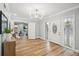 Bright foyer with wood floors, beautiful front door, and a view of the living room at 14333 Lake Magdalene Blvd, Tampa, FL 33618