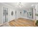 Bright foyer with beautiful front door, gorgeous chandelier, and wood floors at 14333 Lake Magdalene Blvd, Tampa, FL 33618