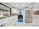 Bright kitchen with white cabinets, stainless steel appliances, and a large farmhouse sink offers style and function at 14333 Lake Magdalene Blvd, Tampa, FL 33618