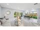 Bright, open-plan living area features marble floors, a modern design, and sliding doors to the outdoor space at 14333 Lake Magdalene Blvd, Tampa, FL 33618