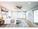 Spacious main bedroom with ample closet space, a ceiling fan, and a private backyard entrance at 14333 Lake Magdalene Blvd, Tampa, FL 33618