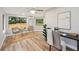 Bright home office featuring hardwood floors, a ceiling fan, a work desk, and picturesque windows at 14333 Lake Magdalene Blvd, Tampa, FL 33618