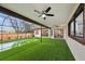 Screened in pool area has artificial grass and ceiling fans at 14333 Lake Magdalene Blvd, Tampa, FL 33618