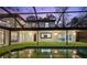 Backyard pool and deck area provides a refreshing outdoor living space with artificial grass and a screened enclosure at 14333 Lake Magdalene Blvd, Tampa, FL 33618