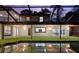 Wonderful view of pool reflecting the home's exterior, lanai, and roof at 14333 Lake Magdalene Blvd, Tampa, FL 33618