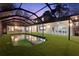 Lovely view of pool reflecting the home's exterior, lanai, and roof at 14333 Lake Magdalene Blvd, Tampa, FL 33618