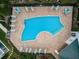 Aerial view of community pool with lounge chairs and outdoor dining tables at 14747 Seminole Trl, Seminole, FL 33776